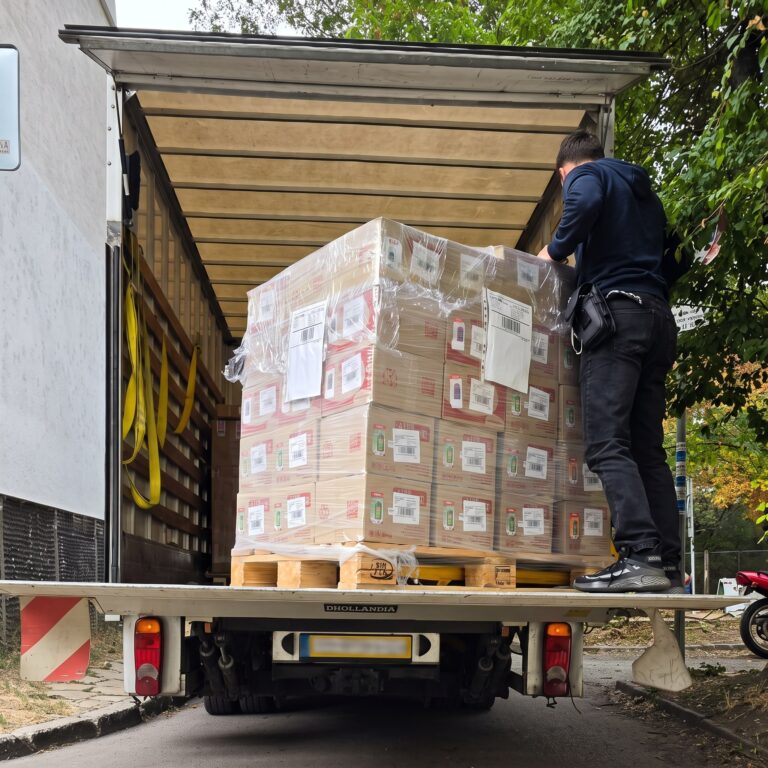 A pallet of client stock on a truck tail lift, wrapped and labelled for Amazon